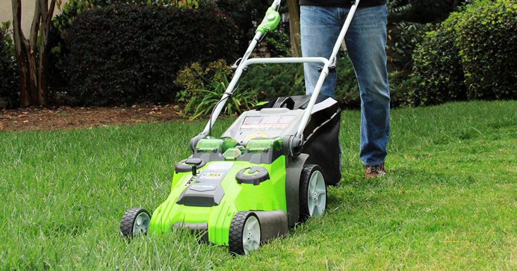 man pushing GreenWorks 20-Inch Cordless 3-in-1 Lawn Mower in yard
