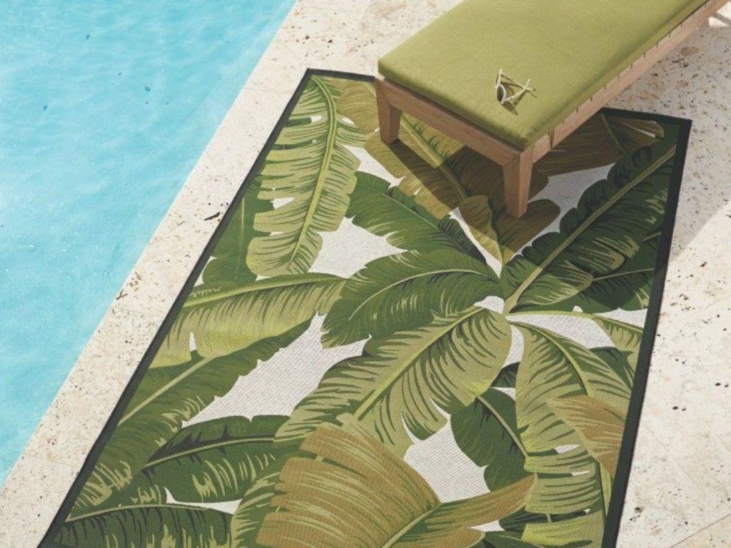 Home Decorators Collection Pindo Ivory/Green 8 ft. x 11 ft. Indoor/Outdoor Area Rug pool side with green lounge chair