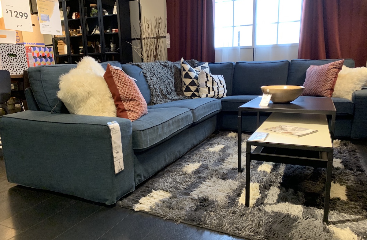 blue denim sectional IKEA couch with pillows 