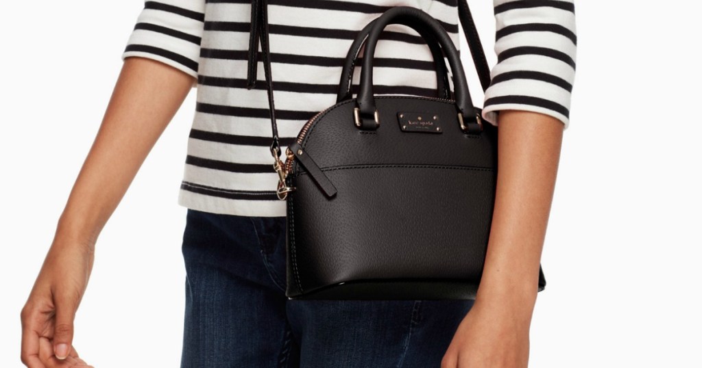 Woman wearing Kate spade brand satchel in black