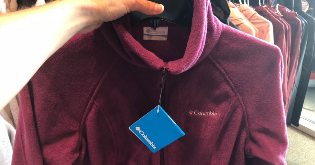 hand holding up columbia fleece jacket