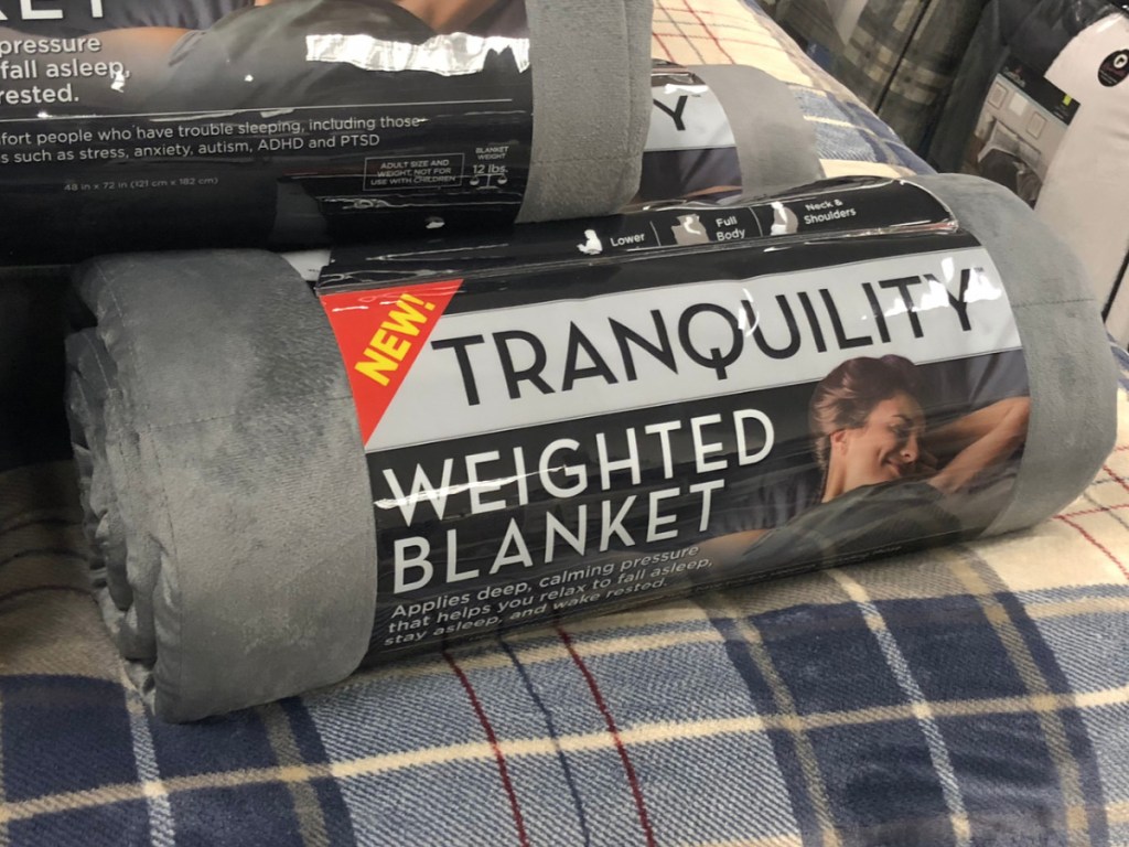 Kohl's Tranquility Weighted Blanket sitting on a bed