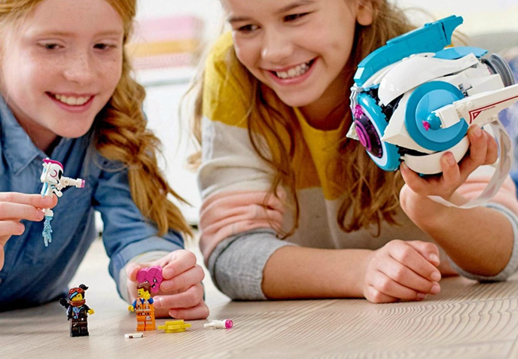 Two girls playing with the LEGO The LEGO Movie 2 Sweet Mayhem's Systar Starship Building Set