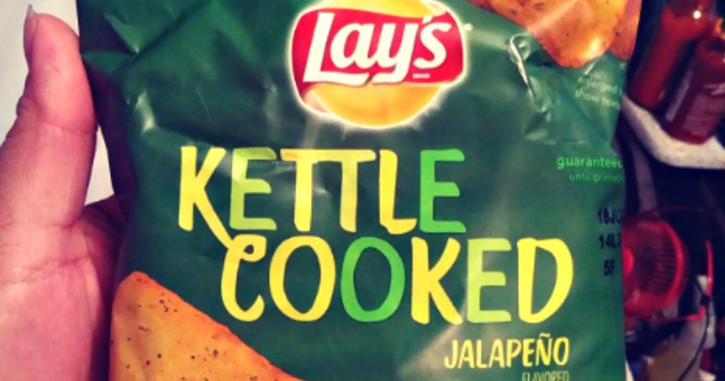 hand holding up bag of lays kettle jalepeno chips