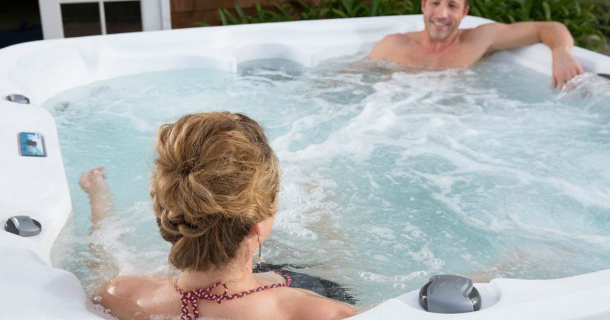 Couple enjoying a large hot tub spa
