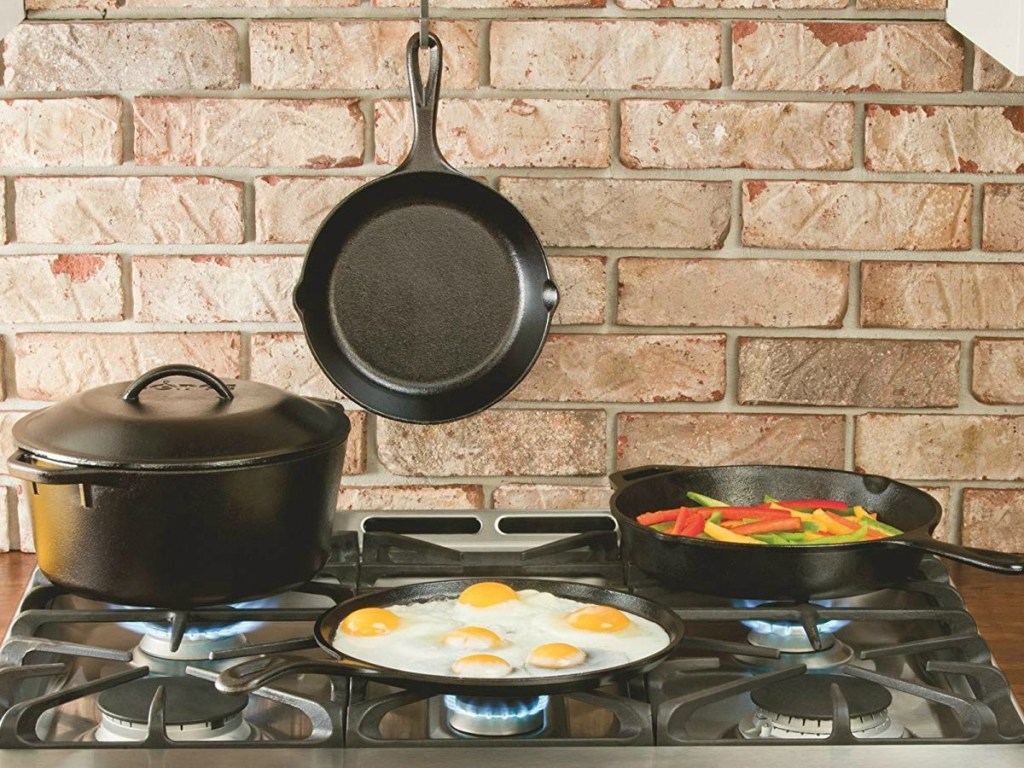 various Lodge kitchenware items in a kitchen with a brick backround