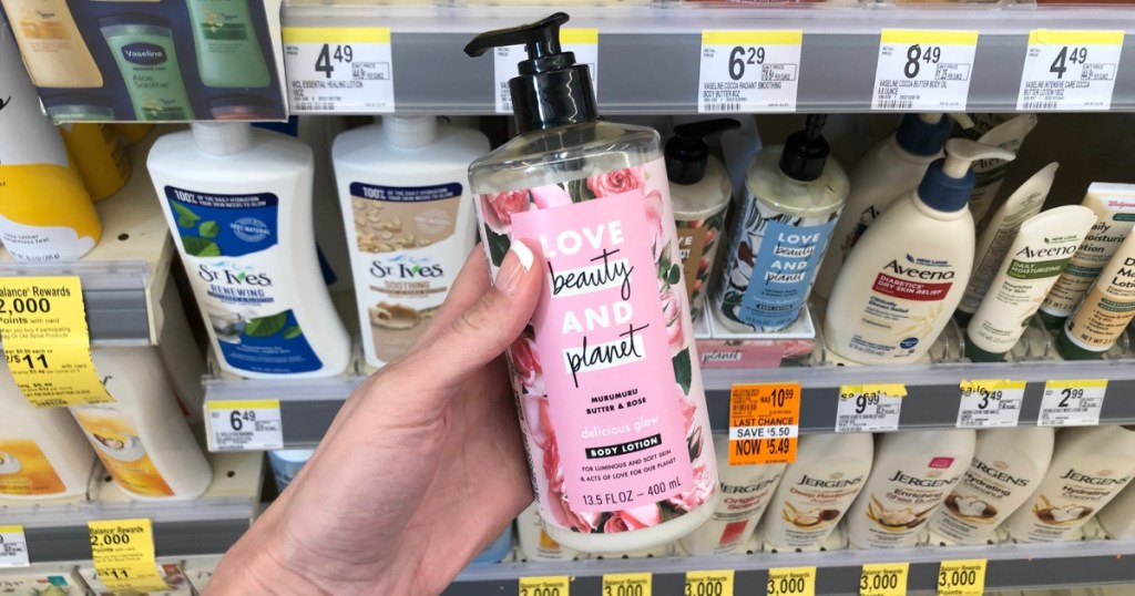 hand holding up bottle of love beauty and planet lotion at walgreens