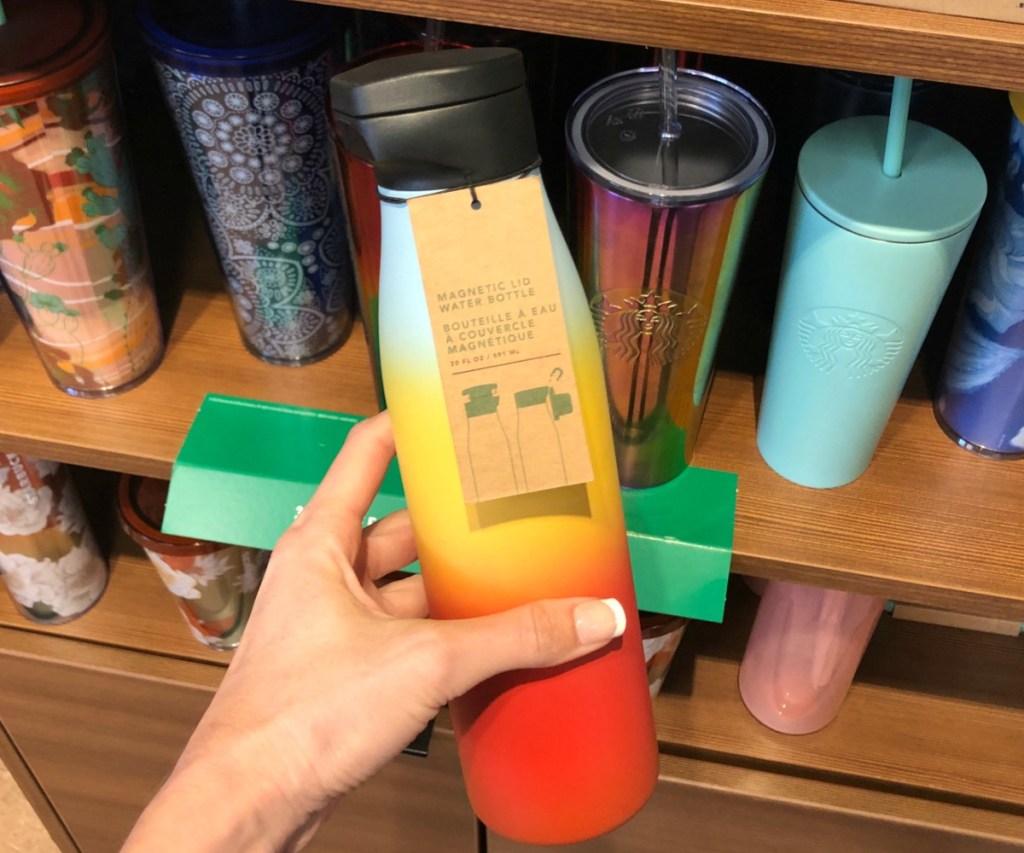 Starbucks brand ombre cup with magnetic lid in hand, in-store