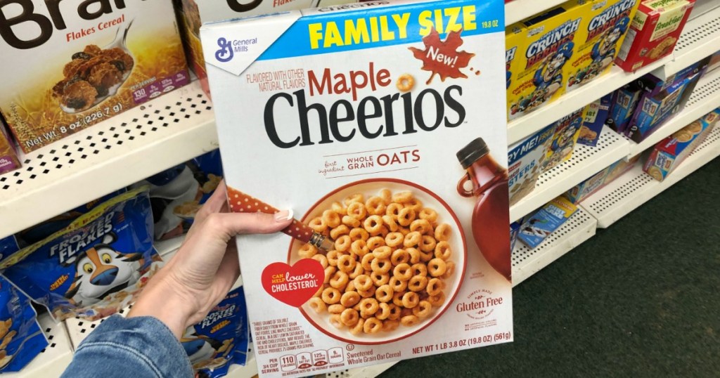 woman holding large box of Maple Cheerios