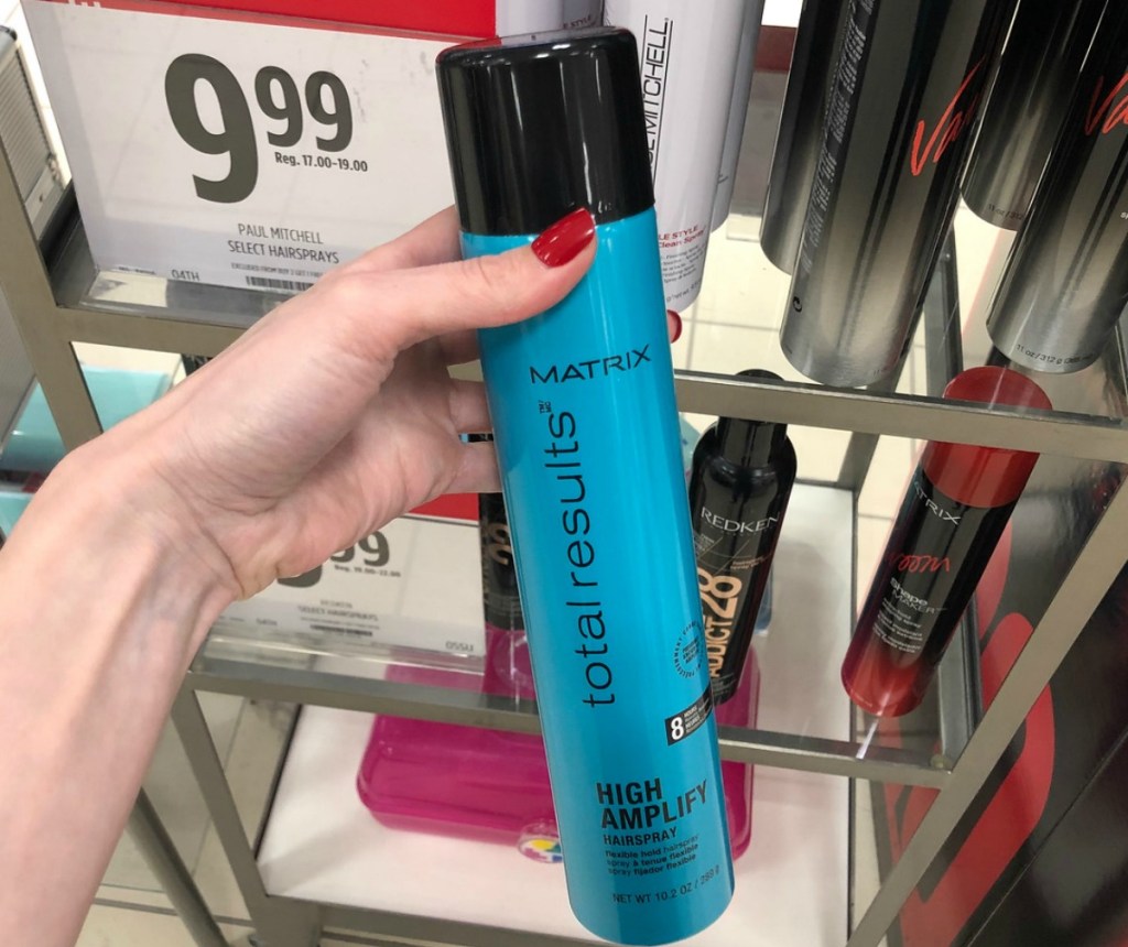 Matrix Hairspray in hand in front of store display