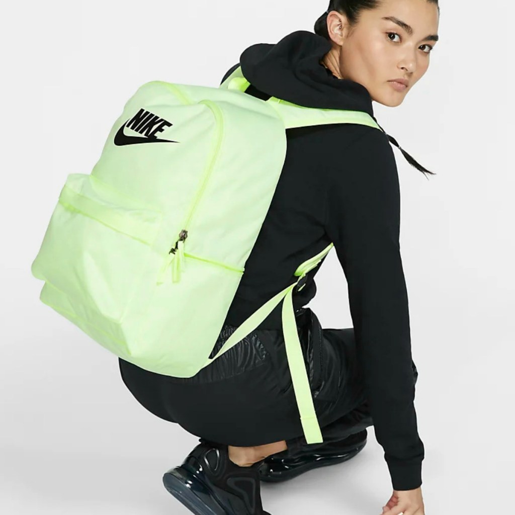 Woman wearing neon colored backpack