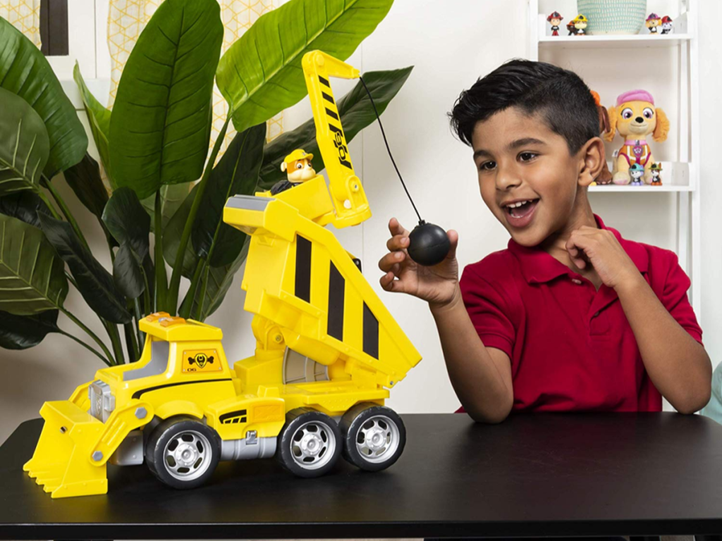 boy playing with paw patrol truck and wrecking ball