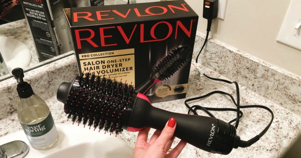 hand holding Revlon Hair Dryer in bathroom with box in the background