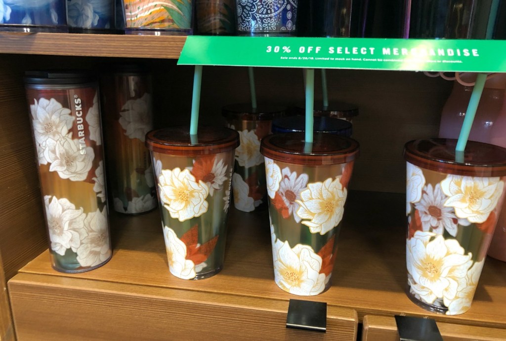 Starbucks floral print tumblers on shelf in store