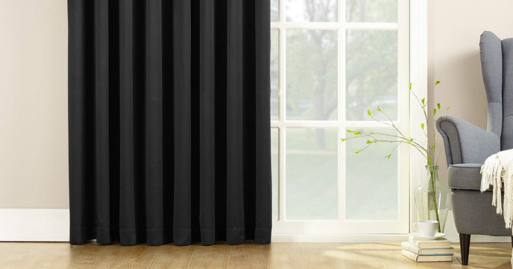 sun zero black curtain panel hanging in living room