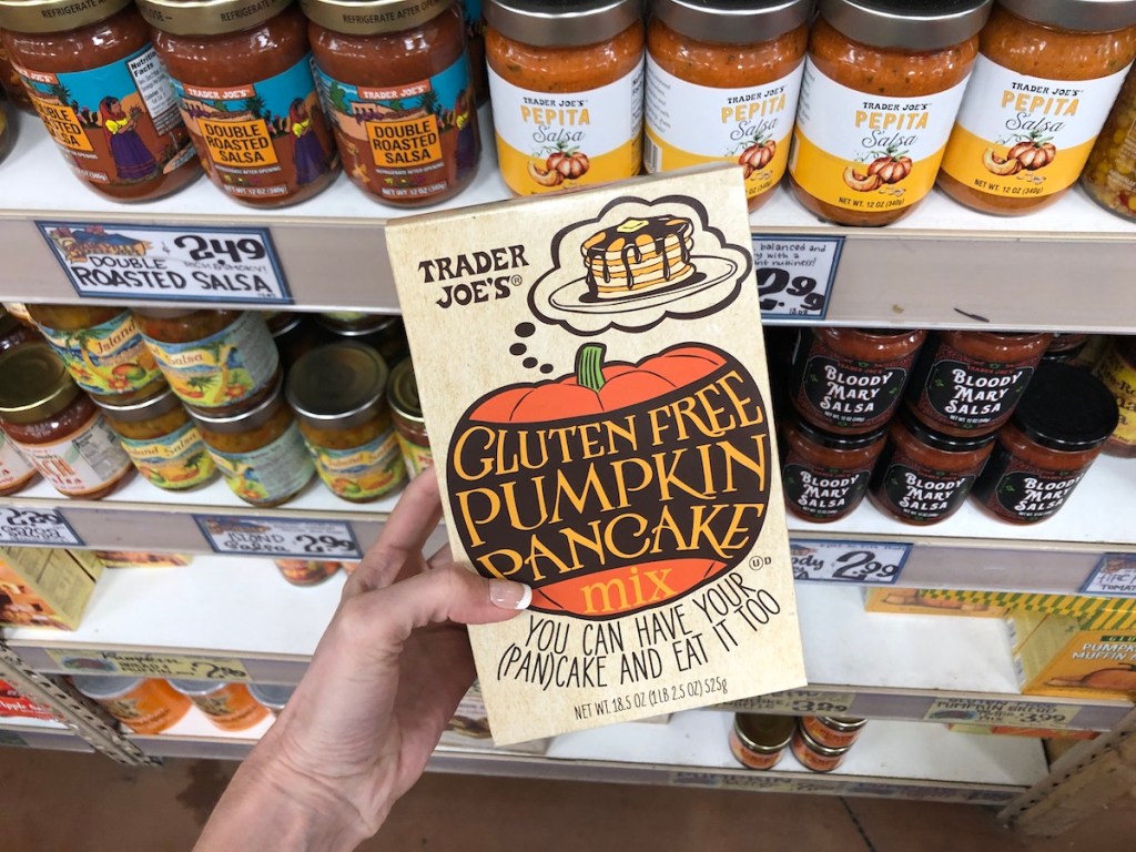 women's hand holding Trader Joe's gluten free pancake mix in store