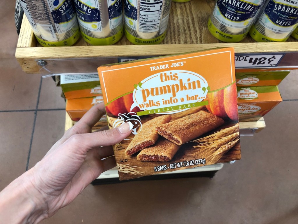 women's hand holding Trader Joe's this pumpkin walks into a bar cereal bars in store