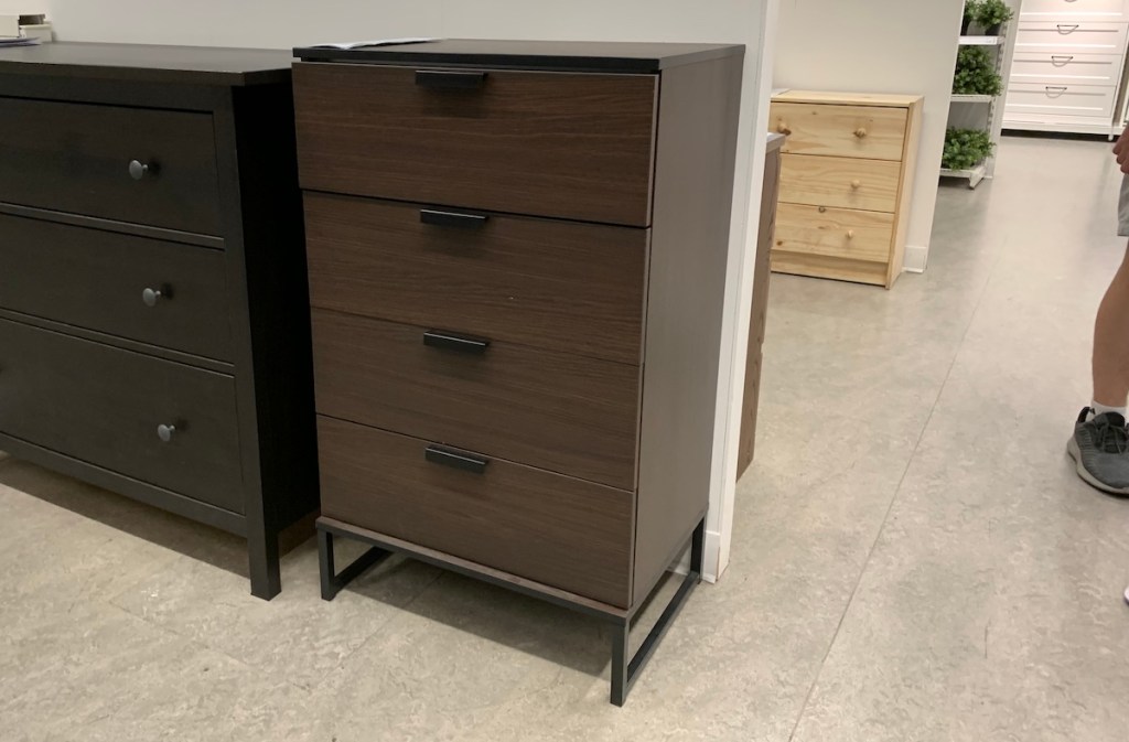 tall chest of dark brown drawers in IKEA store