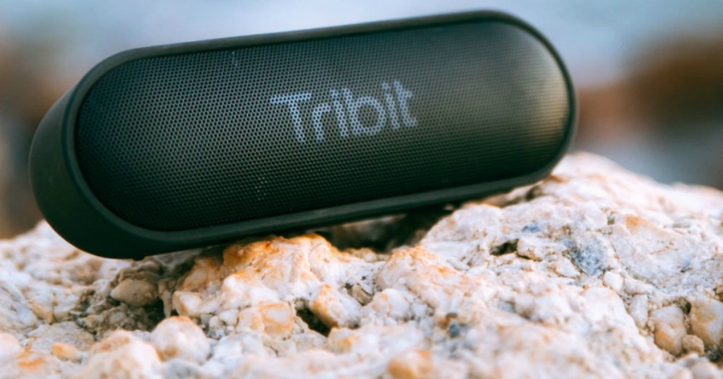 Tribit XSound Go Bluetooth Speaker sitting on rocks