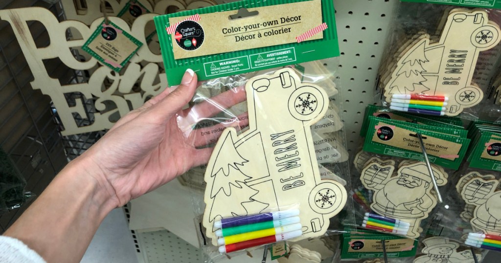 hand holding up wooden color your own decor kit