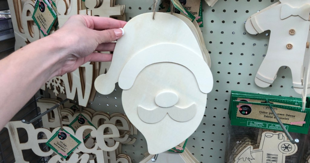 hand holding up wooden santa claus