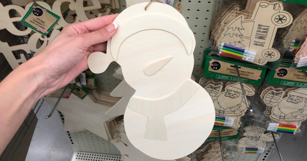 hand holding up wooden snowman