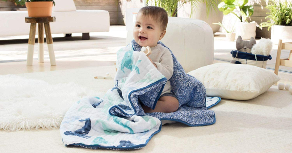 baby wrapped up in dream whale blanket