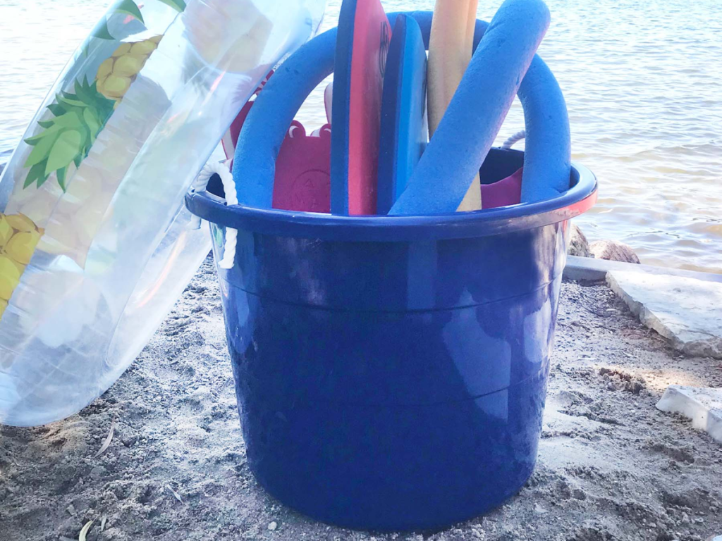 blue bucket holding beach toys