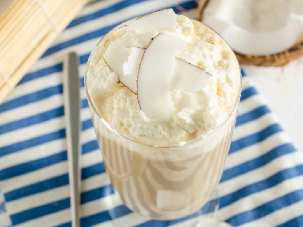 creamy coffee in cup with whip cream