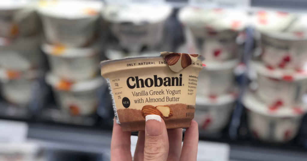 hand holding chobani yogurt with blurred background
