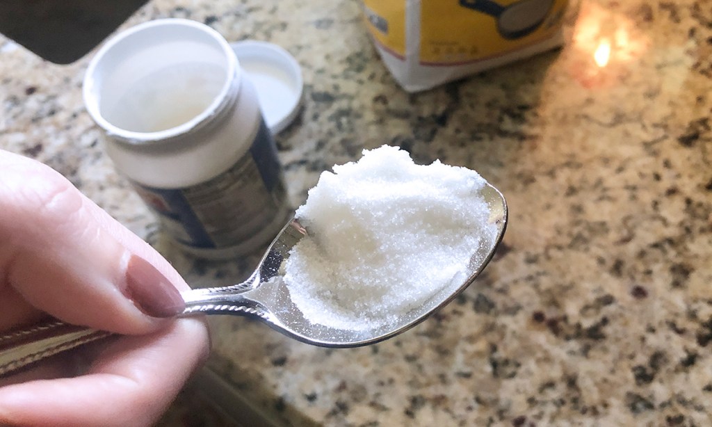 Spoonful of coconut oil with sugar for lip scrub