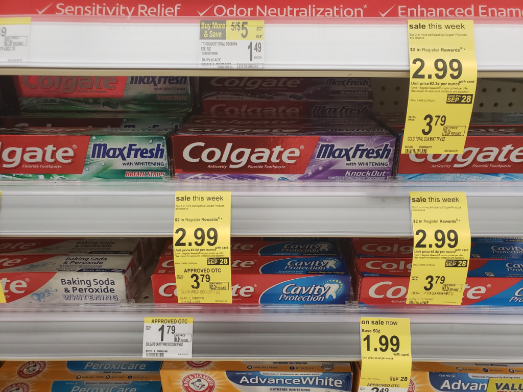 colgate toothpate on walgreens store shelf with sale tags