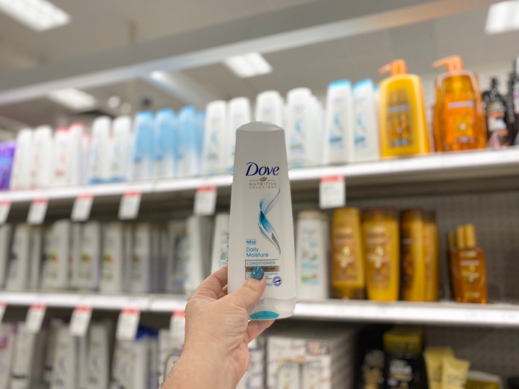 Hand holding up dove haircare at target