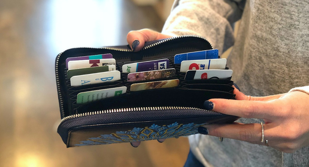 person holding a wallet with credit cards inside