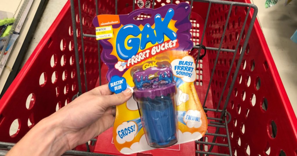 hand holding gak in front of target cart