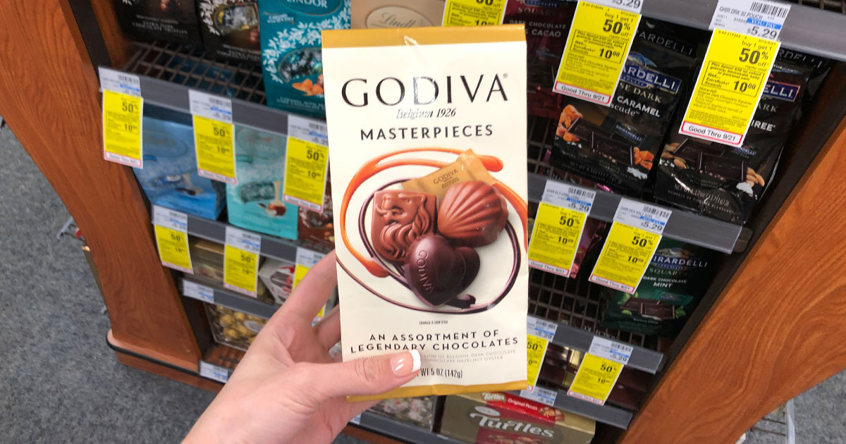 Hand holding bag of Masterpieces Chocolate at CVS