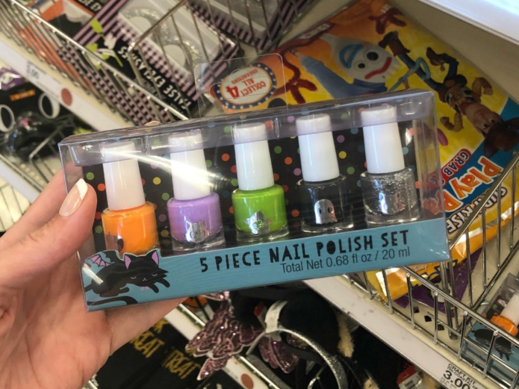hand holding package with nail polish by store display