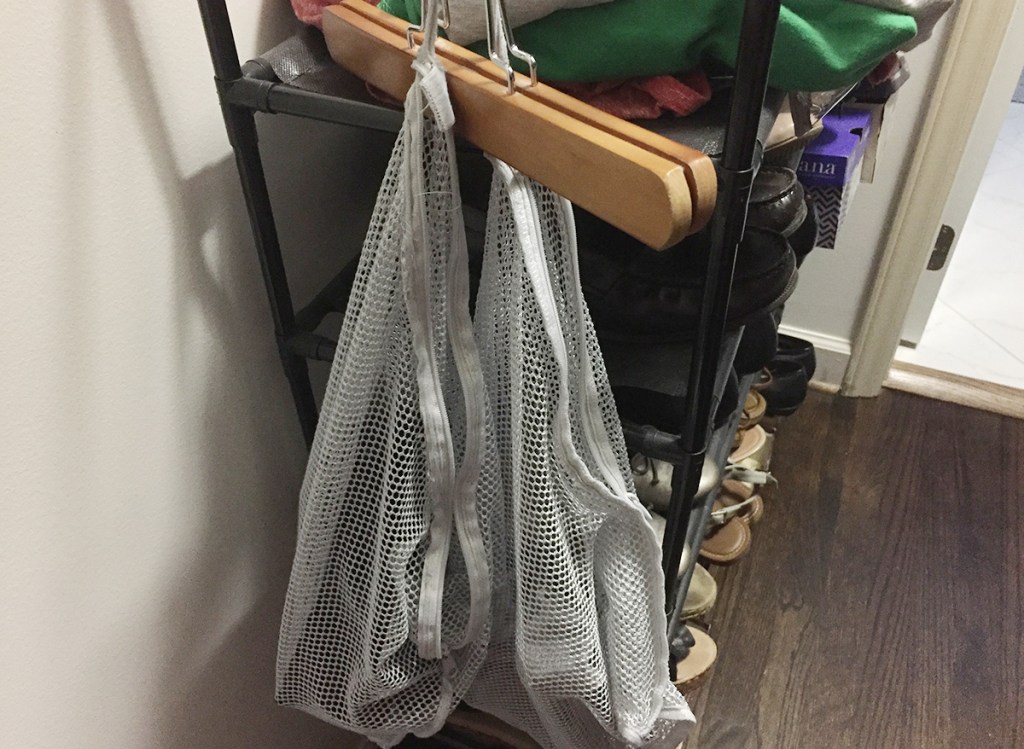 mesh laundry bags hanging in closet