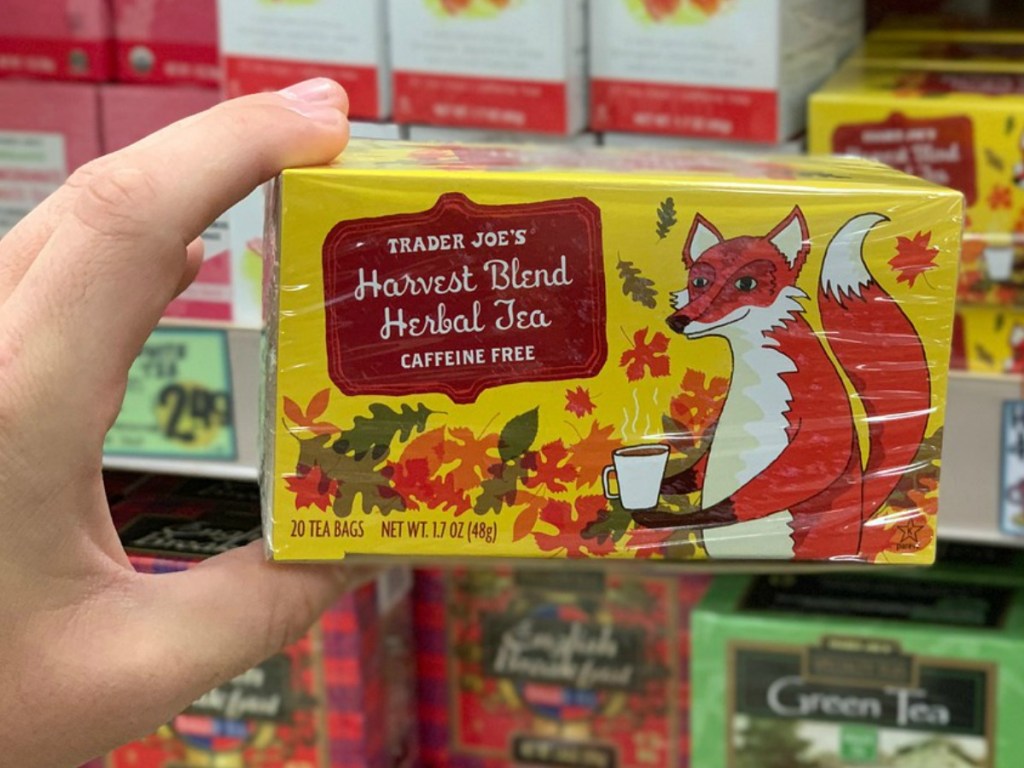 hand holding box of tea by store display