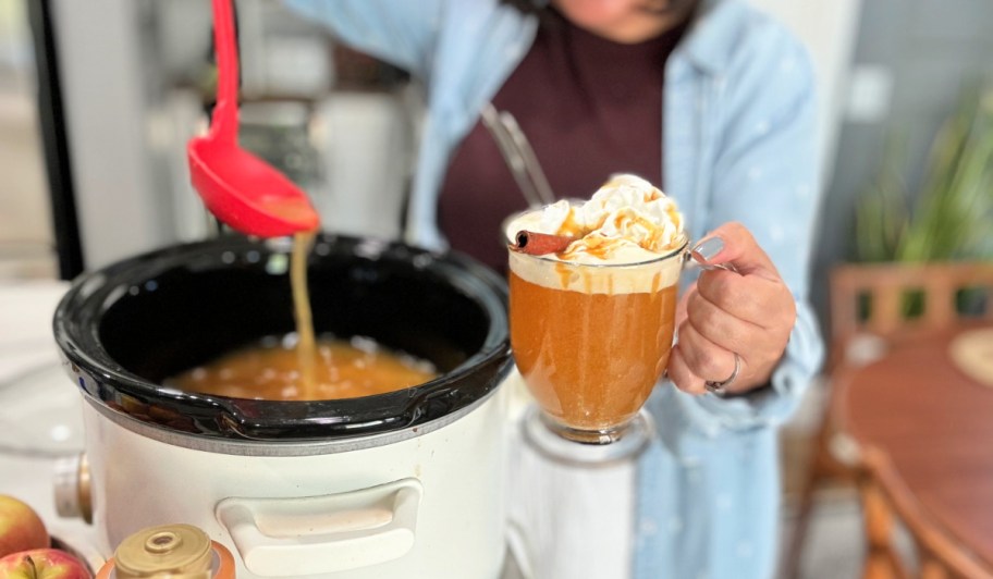 holding a cup of apple cider