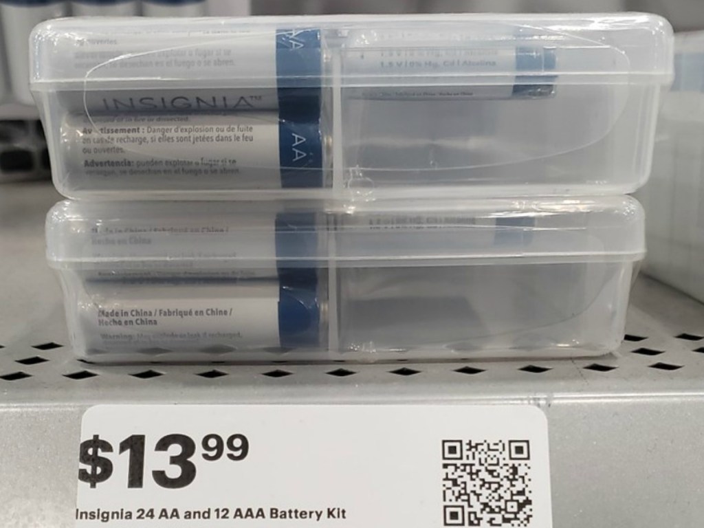 pack of batteries in plastic case on store shelf by price tag