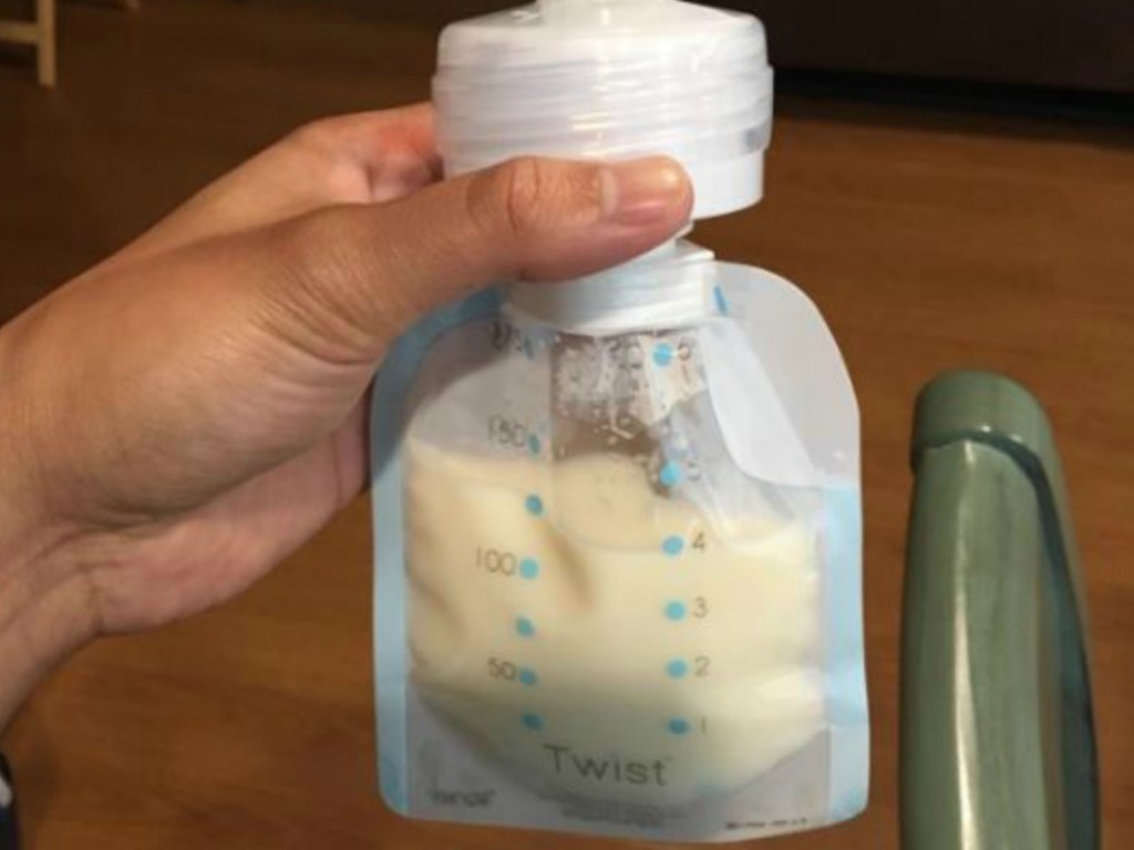 hand holding bag of breast milk