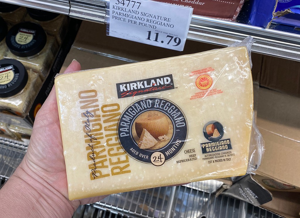 hand holding kirkland cheese at costco