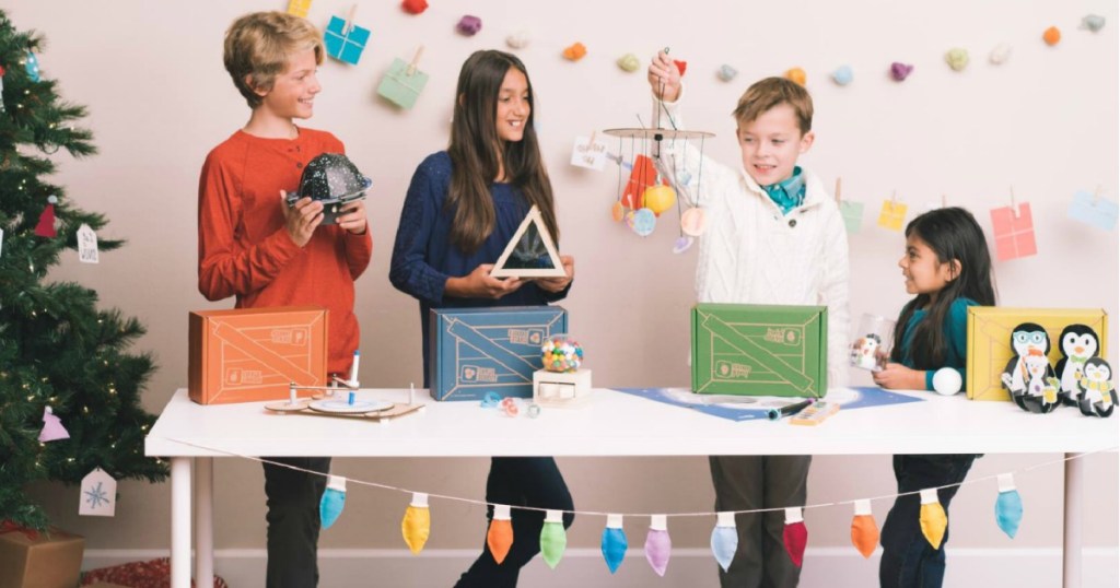 kids standing around a table holding crafts