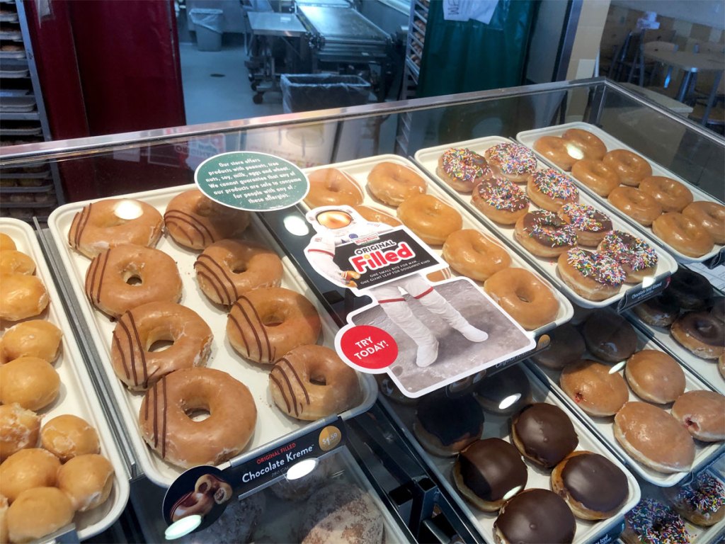 racks of Krispy Kreme doughnuts in store