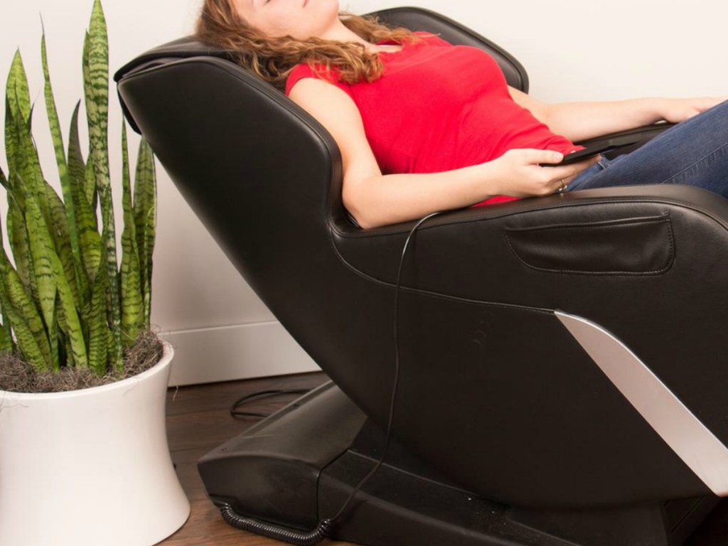 woman reclining in brown massage chair