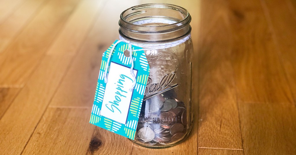 Money jar full of coins with shopping tag