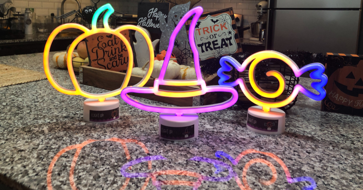 pumpkin witch hat and candy neon lights on counter