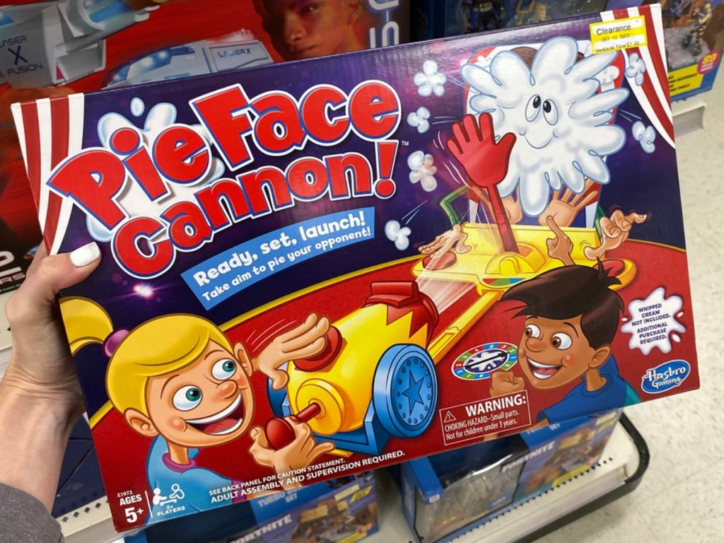 hand holding game in store by shelves