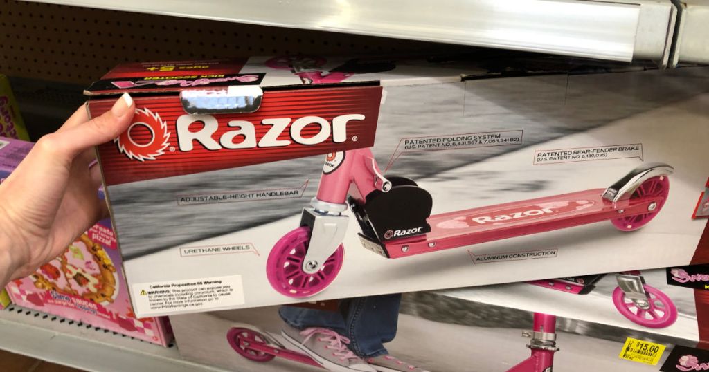woman hand holding pink razor scooter at walmart